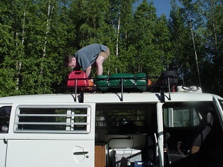 Brian strapping cargo, combustibles and the "Quik Shade" securely to the roof rack.