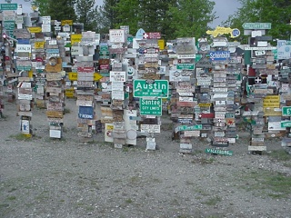 A very small piece of the Watson Lake sign forest. If you look closely, I'll bet you can't see Brian's head left and below of the Austin sign.
