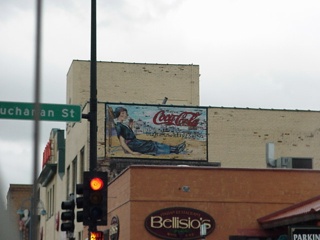 An old Coke advertisement painted on a wall