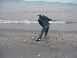 Theresa, practicing Tai Chi (or skipping a rock, or something like that...)