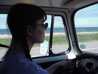 Theresa focusing on keeping the bus on the road with Lake Superior in the background