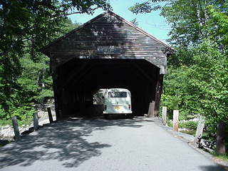 The bus, being drawn into a covered bridge on the Kancamagus Highway