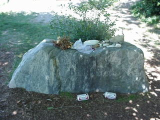 The small shrine opposite the grave stone had all sorts of memorials