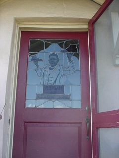 The original "shoe king" memorialized in stained glass on the front door