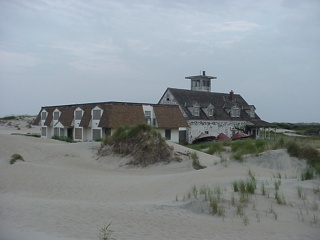 What appears to be a former resort, disappearing into the dunes