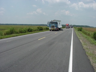 A truck that had sadly lost half of someone's home off of it's flat bed