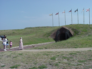 A lady in historical garb leading a tour at Fort Morgan in Alabama
