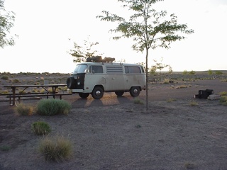 The bus sporting the "fauxdobe" look in our heavily wooded site at Homolovi Ruins State Park