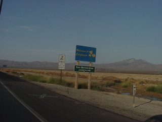 That sign says "Welcome to California- where it will be 115 degrees right here today"