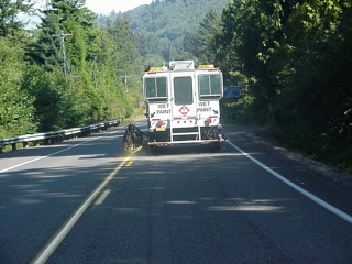 A truck repainting the lines of the road. You be the one to pass it.
