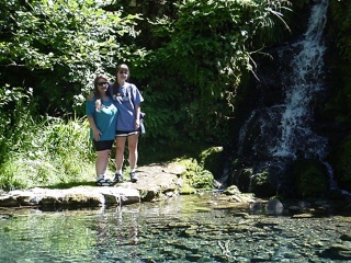 Theresa and her mom posing for a shot next to a waterfall