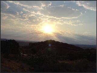 The morning sun breaks through, over some folks we don't know