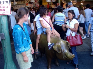 The kids get mom to feed the pig