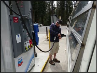 Brian fighting one of those Californian environmentally safe gas nozzles