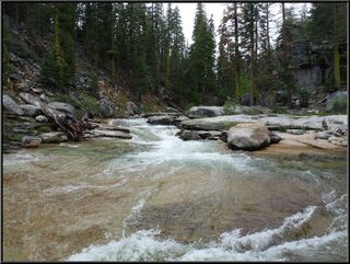 Water cascading over rock above the falls