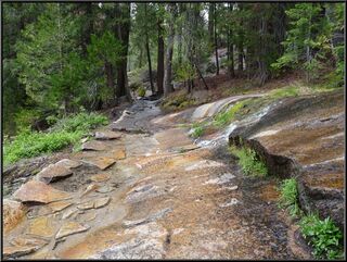 Water rushing over the trail