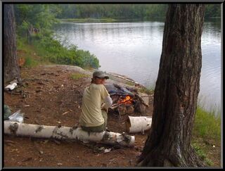 Theresa warming by the campfire. The face is sadness for Lumix, as I shoot a photo with the iPhone