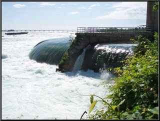The river above the falls and a barge that looks like it got stuck in a lucky spot