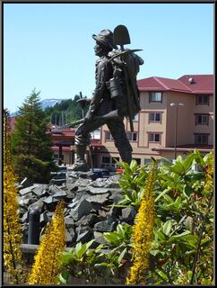 The pioneer in front of the Pioneer House