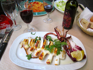 A sidewalk dinner near the rail station. Theresa had squid.