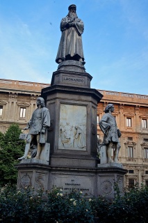 With a statue of the man