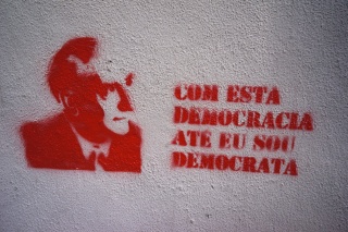 "With this democracy until I am a democrat". Not sure exactly the sentiment, but like the stencil