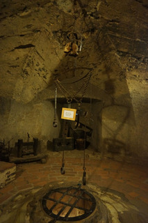 In the cellar. Another body cage, over the hole to the dungeon. A bad looking place