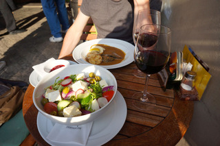Some simple Czech cuisine. A plate of meat and dumplings, salad, local wine
