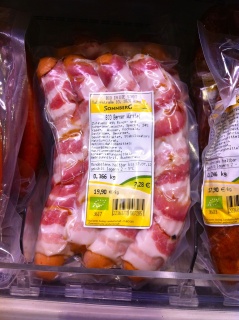 Sausage wrapped in bacon in an organic market. Awesome