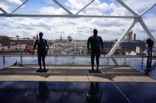 A couple of bronzes with the Paris skyline in the background