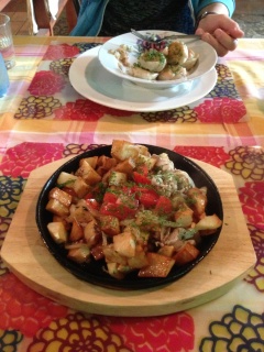 Dinner at the Soviet Cafe. Pork, potatoes and tomatoes for him. Russian raviolis for her.