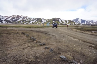 Crazy green mountains at a fork in the road
