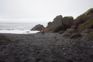 Theresa in the morning on the black sand beach in Vik