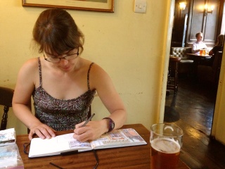 Theresa sketching over a pint in the pub