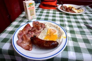 Full English at Maria's — bacon, egg, sausage, checkered tablecloth