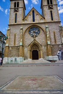 A Sarajevo Rose in front of The Sacred Heart Cathedral. Mortar impacts filled with red resin