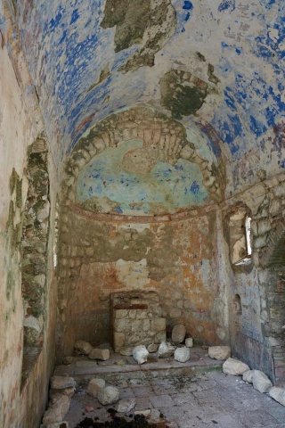 Inside, old frescoes and animal poop