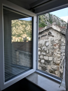 Last look out the Kotor window: stone, red tile, mountains.