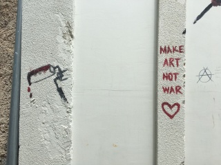 MAKE ART NOT WAR. The neighborhood's whole pitch.