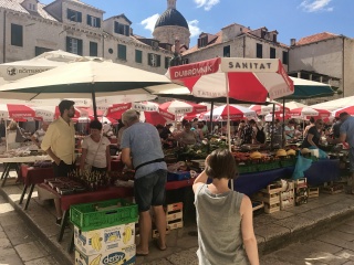 Gundulić Square market under its red umbrellas.