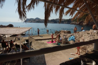 Thatched shade over the cove. A swim we admired and skipped.