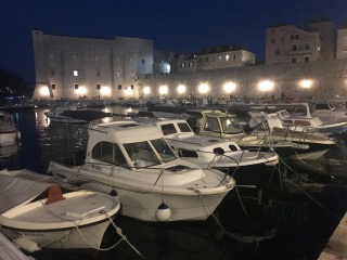 Old Port at night, boats glass-still under the walls.