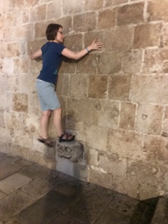 Theresa on the supetar—face to the wall, one foot up, no hands. Local custom.