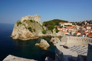 Onto the wall, the cliffs falling away to the sea.