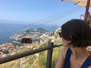 She watches the city come up to meet us.