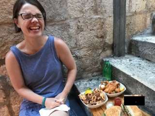 Takeaway calamari on a quiet flight of steps. She's pleased.
