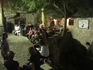 Courtyard café, full house, after dark.