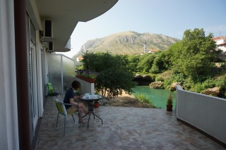 Theresa, the terrace, the river behind her.