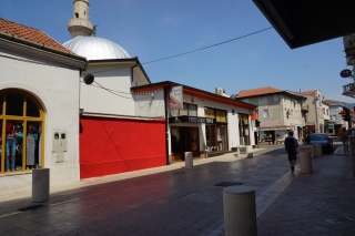 Mosque, then shuttered shops. Mostar.
