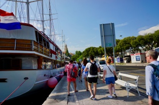 Down the quay, past the tall ship.